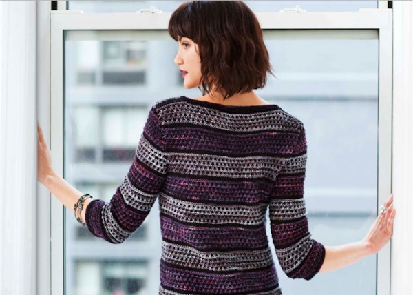image of a women from the back looking back and wearing wool diver with malabrigo yarn