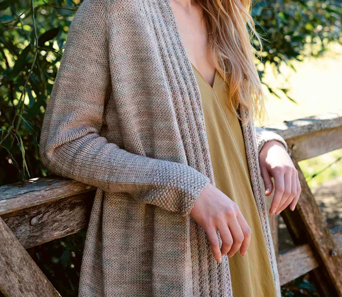 Woman wearing a cardigan made with malabrigo yarn.